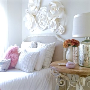white shabby chic bedroom with blush furry pillow and throw..
