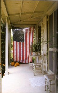 Large American Flag on porch with pumpkins . http://www.kristywocks.com
