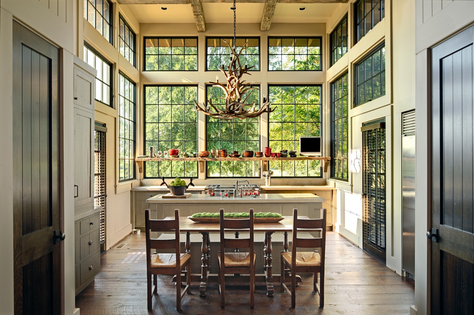 Rustic kitchen full of light and windows with open shelving by Jeffrey Dungan. https://kristywicks.com